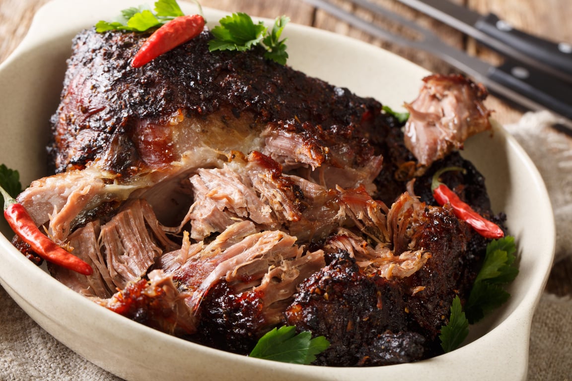 American food Pernil Asado shredded pork closeup on a plate on the table. horizontal